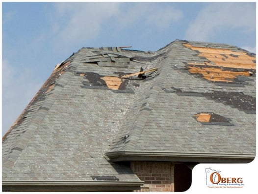 Wind-damaged roof with missing shingles
